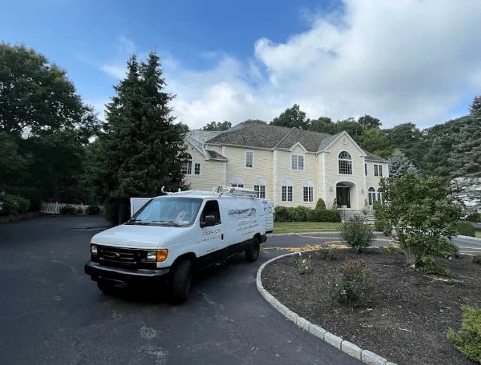 Rocky River Power Washing technician performing thorough gutter cleaning service in Rocky River